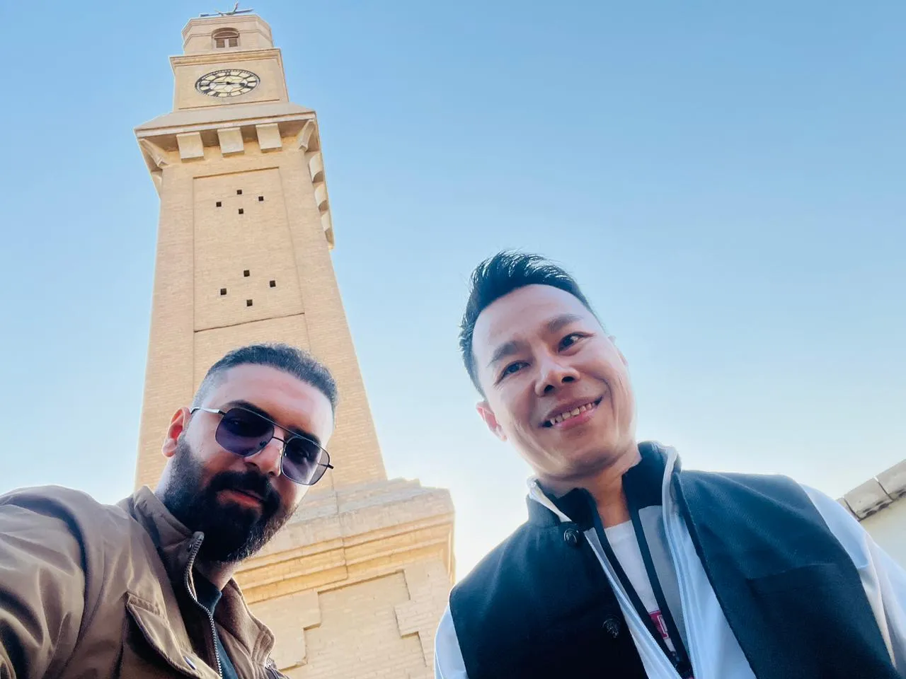 Two travellers below the Ottoman clock tower in the Qishla courtyard, Baghdad.